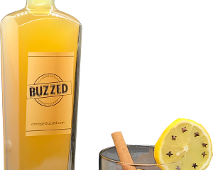image of comegetbuzzed.com's mango madness in bottle and a glass with garnish